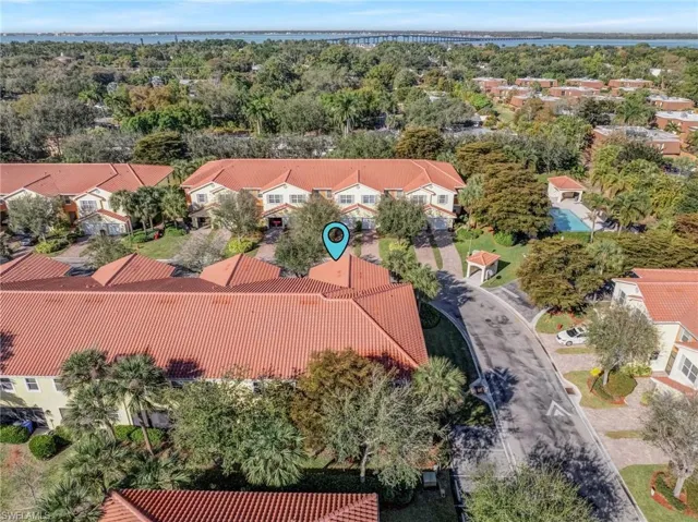 Aerial perspective of suburban area featuring a large body of water and a notable bridge