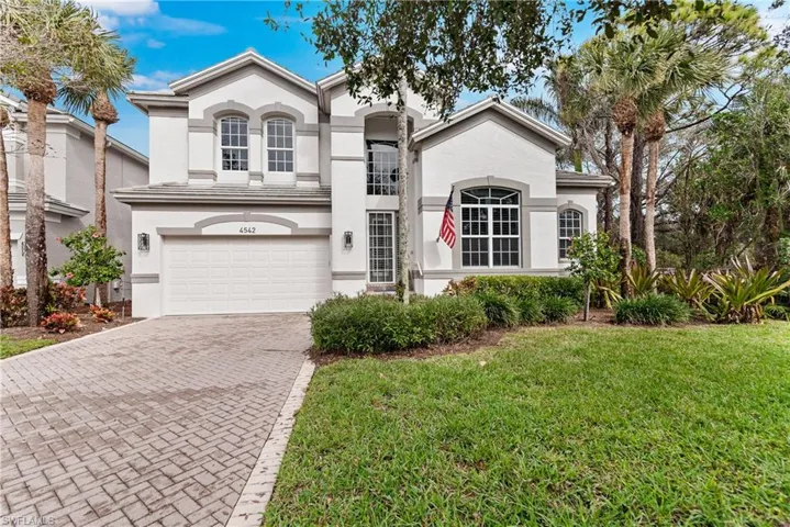 View of front of home featuring a garage and a front yard