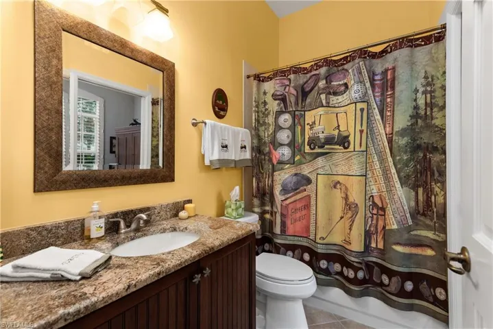 Bathroom with toilet, tile patterned flooring, and vanity