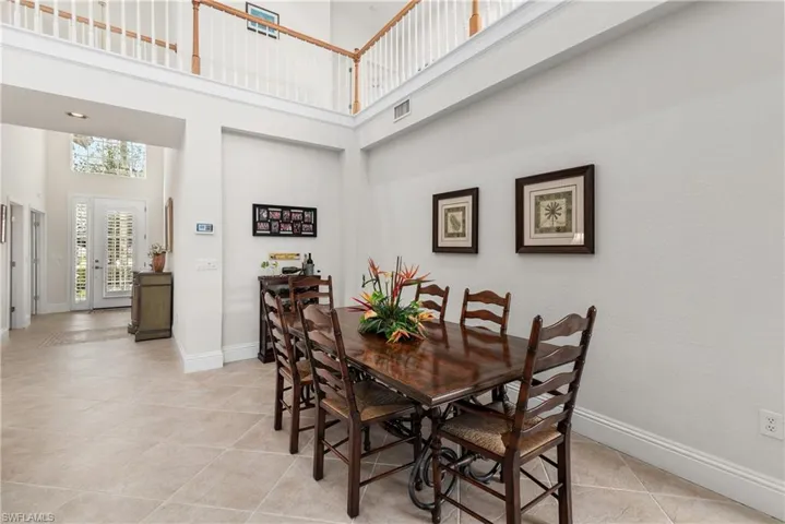 Tiled dining space with a high ceiling
