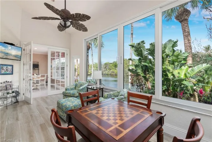Sunroom featuring a water view and ceiling fan
