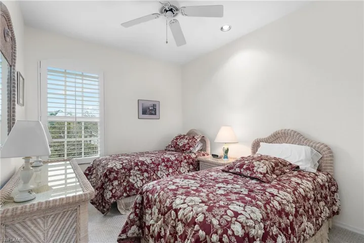 Bedroom with ceiling fan and carpet