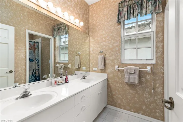 Bathroom with vanity and tile patterned flooring