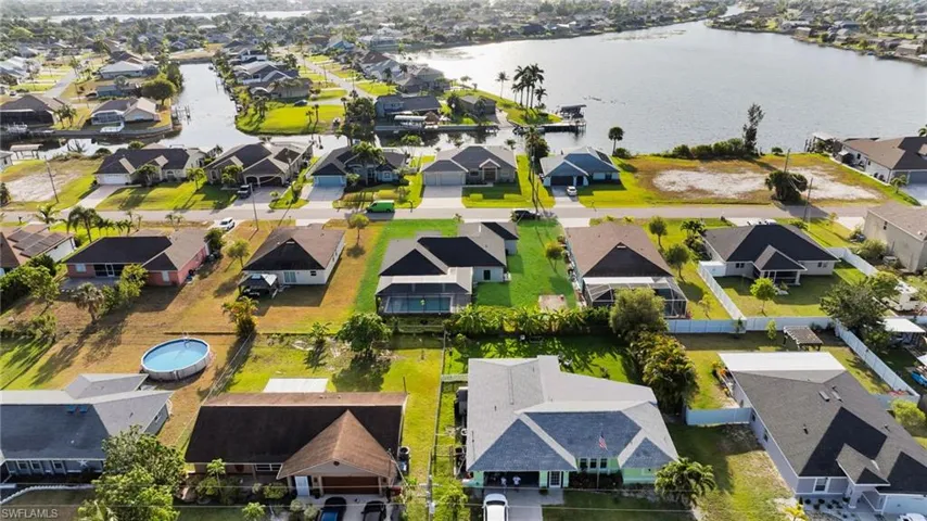Aerial view featuring a residential view and a water view