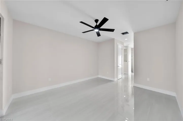 Empty room with ceiling fan, recessed lighting, visible vents, and baseboards