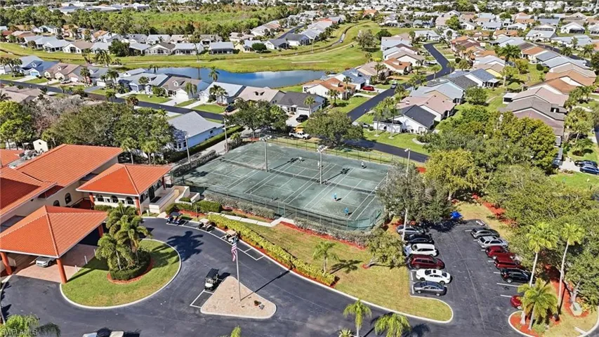 Aerial view of property's location featuring a nearby body of water and nearby suburban area