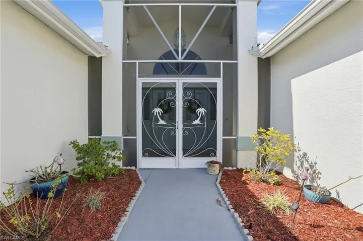 Entrance to property featuring stucco siding and french doors