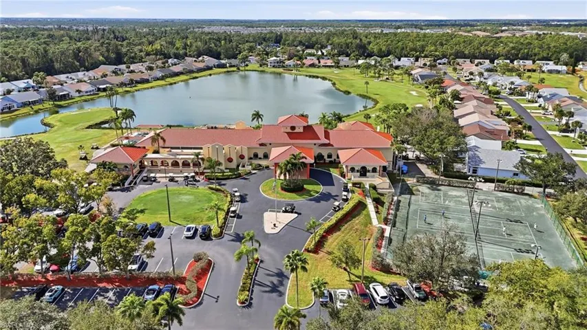 Aerial perspective of suburban area with a nearby body of water and a golf club