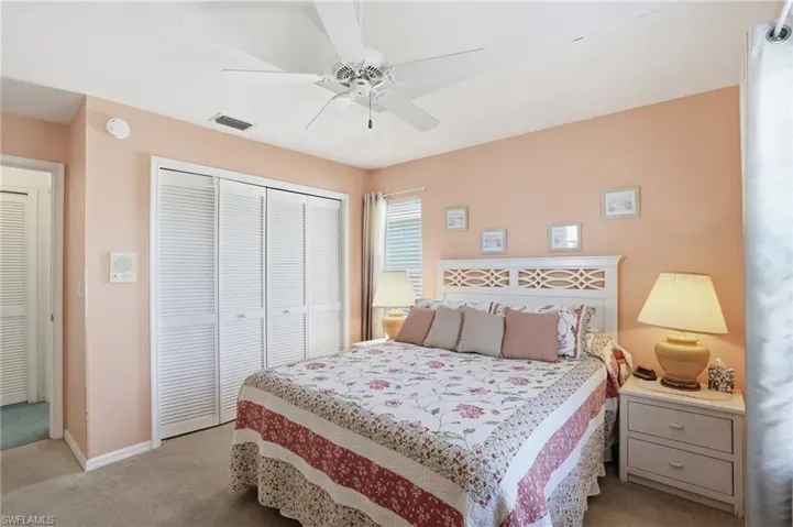 Bedroom with carpet flooring, a closet, and ceiling fan