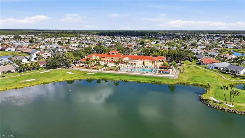 Aerial view of residential area with a local golf course and a large body of water