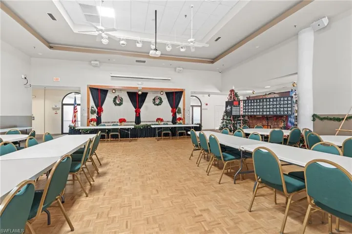 Dining area with parquet flooring and a high ceiling