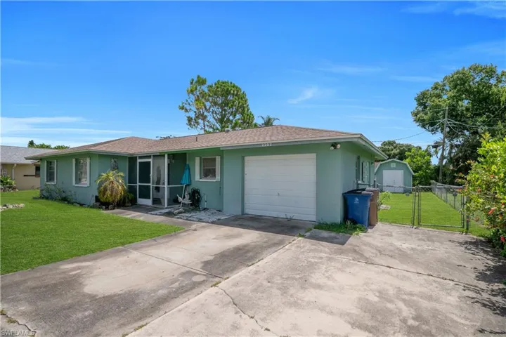 Single-story residence featuring a screened entry, attached garage, and a concrete driveway