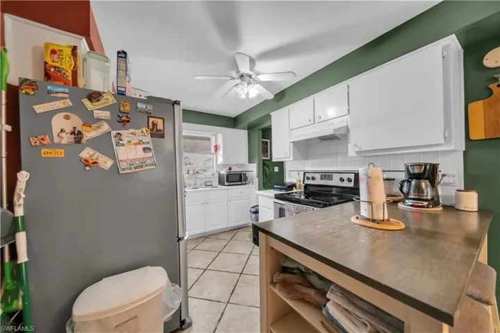 Kitchen island with wood-finish countertop, white base, and seating for two