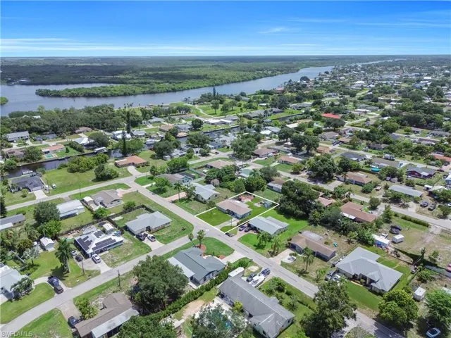 Aerial overview showcasing a residential neighborhood with a prominent river backdrop