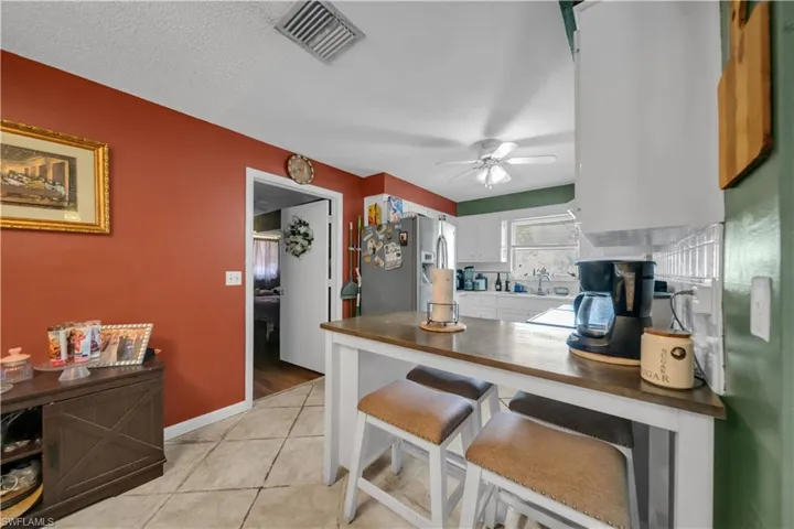 Dining area featuring a decorative chandelier, tile flooring, and a glass-paneled door