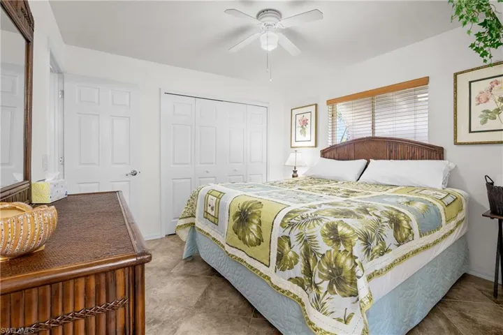 Bedroom with ceiling fan and a closet