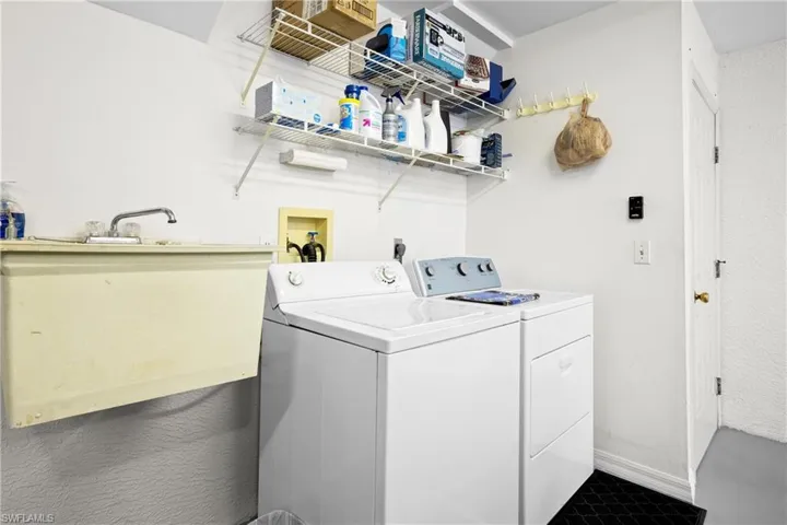 Washroom featuring washing machine and clothes dryer