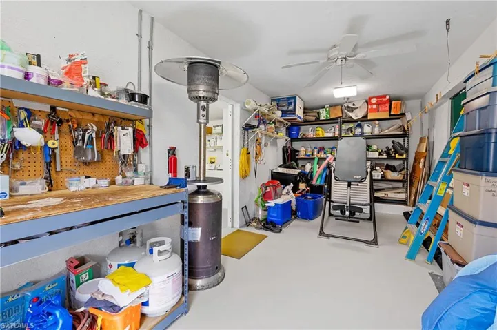 Garage featuring a workshop area and ceiling fan