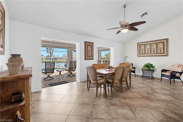 Dining space with a wealth of natural light, light hardwood / wood-style flooring, ceiling fan, and lofted ceiling