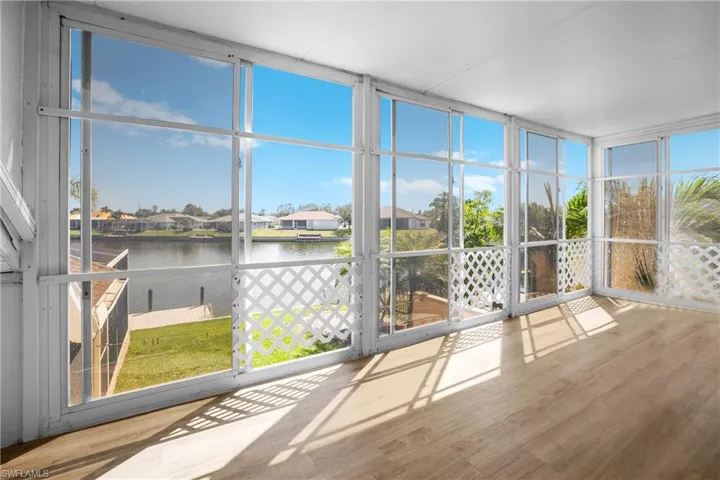 Unfurnished sunroom with plenty of natural light and a water view