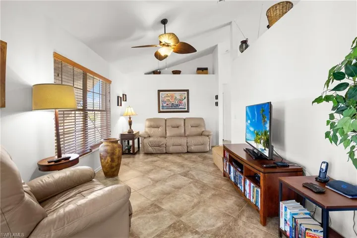 Living room with ceiling fan and vaulted ceiling