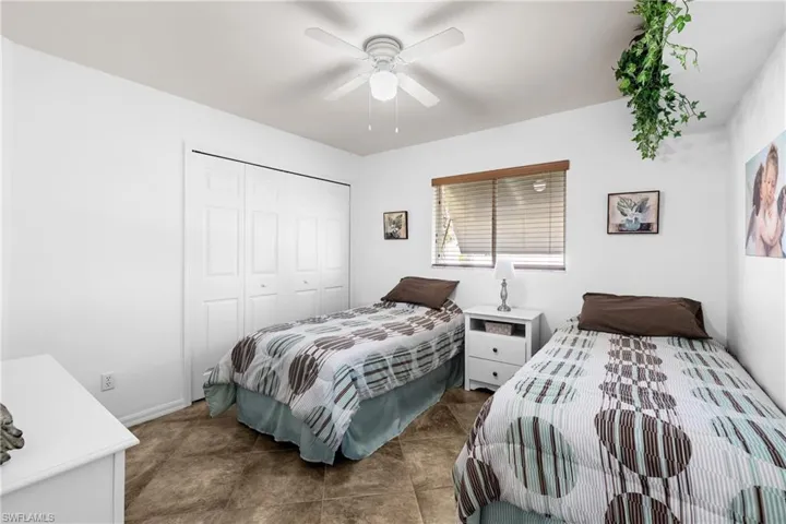 Bedroom with ceiling fan and a closet