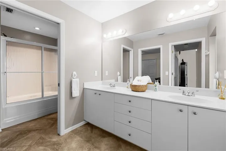 Bathroom with tile patterned flooring and vanity