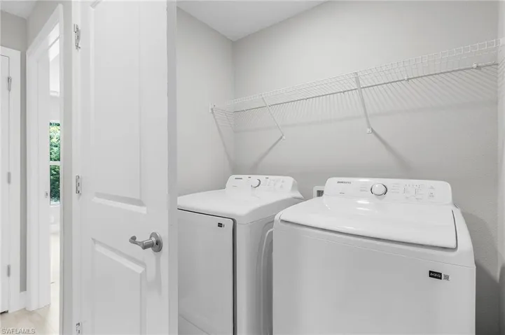 Clothes washing area featuring washer and dryer