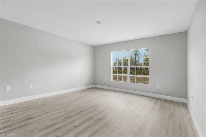 Empty room with light wood-style floors and baseboards
