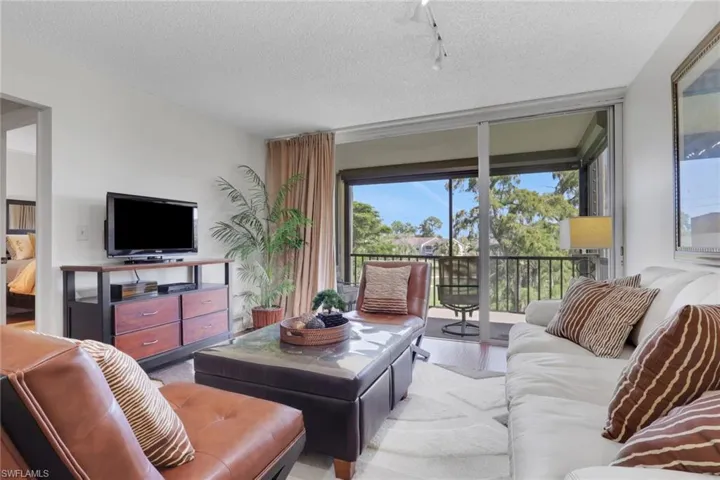 Living area with a textured ceiling and wood finished floors