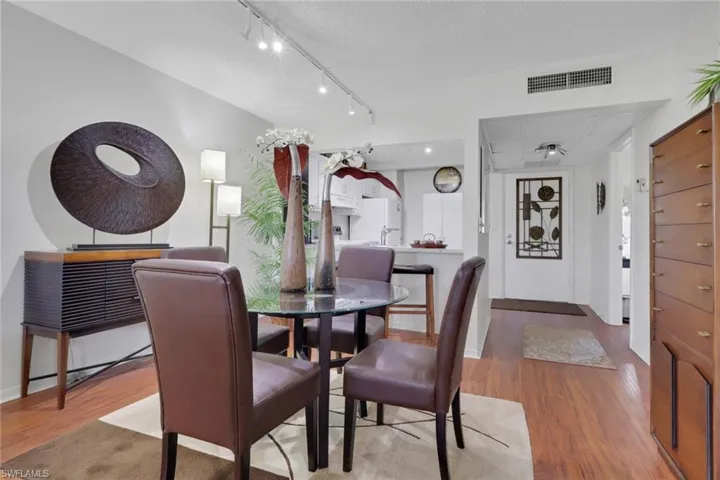 Dining room with wood finished floors and a textured ceiling
