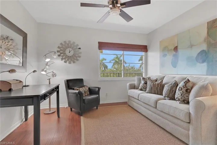 Living room with wood finished floors and ceiling fan