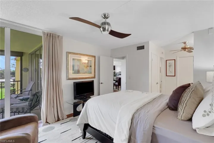 Bedroom with access to outside, a ceiling fan, and a textured ceiling