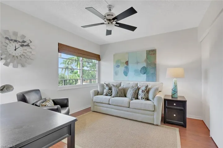Living room featuring wood finished floors, ceiling fan, and a textured ceiling