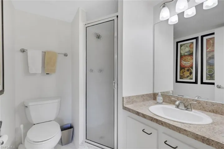 Bathroom featuring vanity and a shower stall