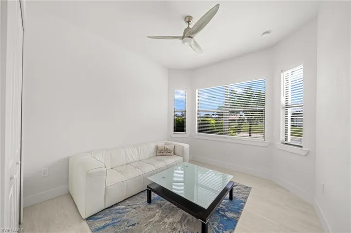Living area with a ceiling fan and wood finished floors