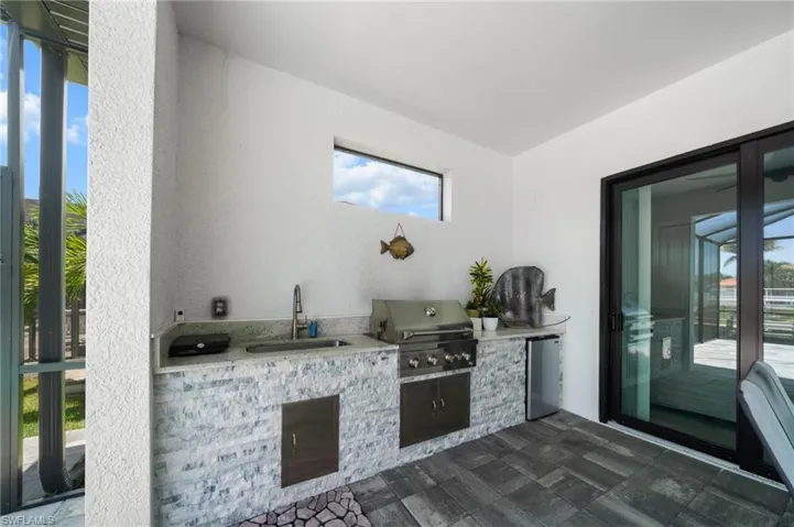 View of patio / terrace featuring an outdoor kitchen and a sink