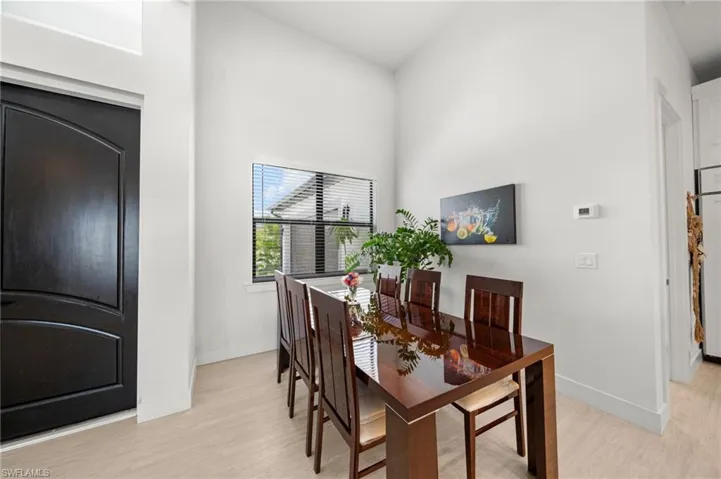 Dining area featuring light wood-style floors and baseboards