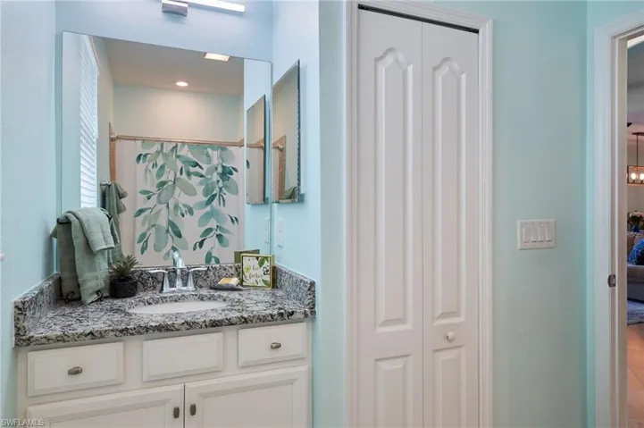 Bathroom with vanity and curtained shower