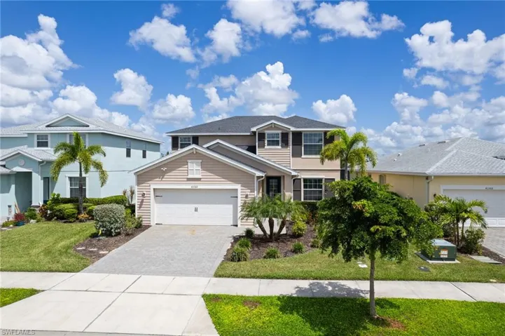 Front of property featuring a garage and a front yard