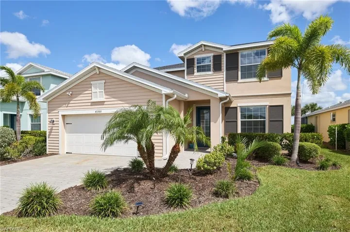 View of front facade featuring a garage and a front yard