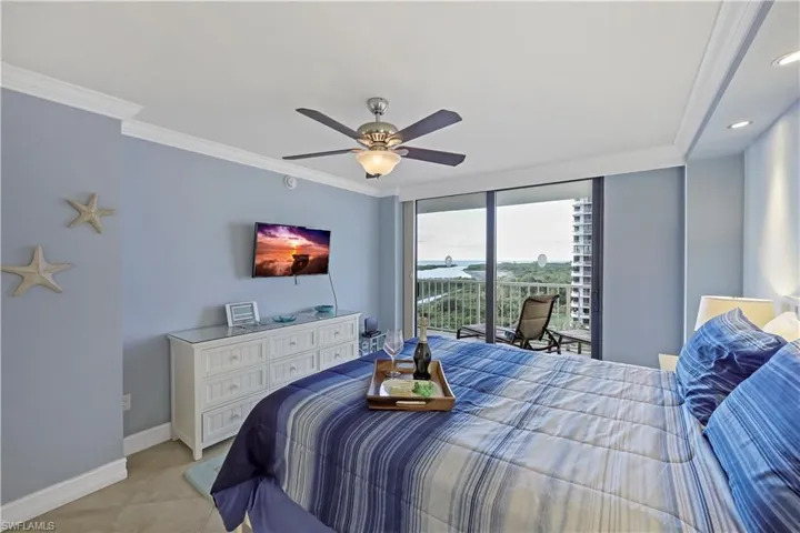 Tiled bedroom with access to exterior, crown molding, floor to ceiling windows, and ceiling fan