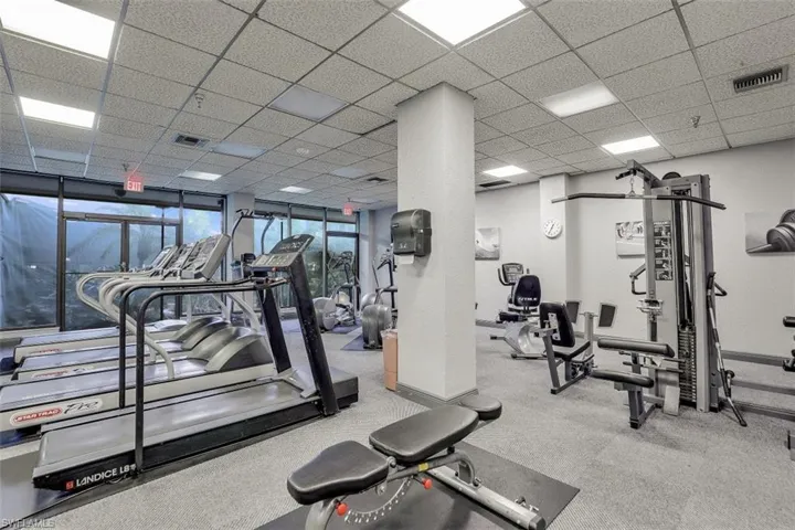 Workout area featuring a drop ceiling