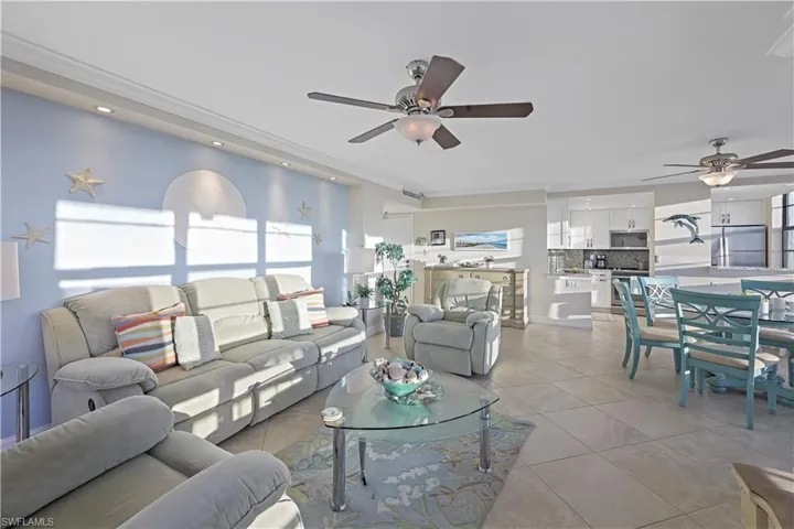 Living room featuring ceiling fan and light tile patterned flooring