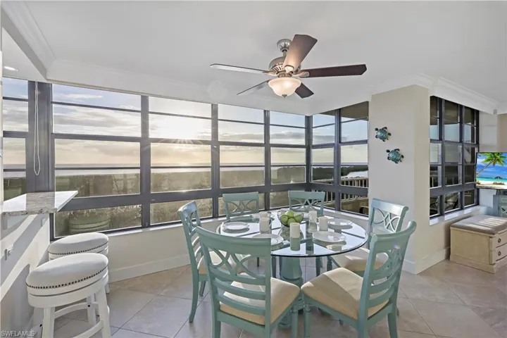 Sunroom with a healthy amount of sunlight and ceiling fan