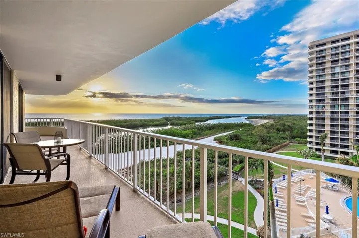 Balcony at dusk featuring a water view