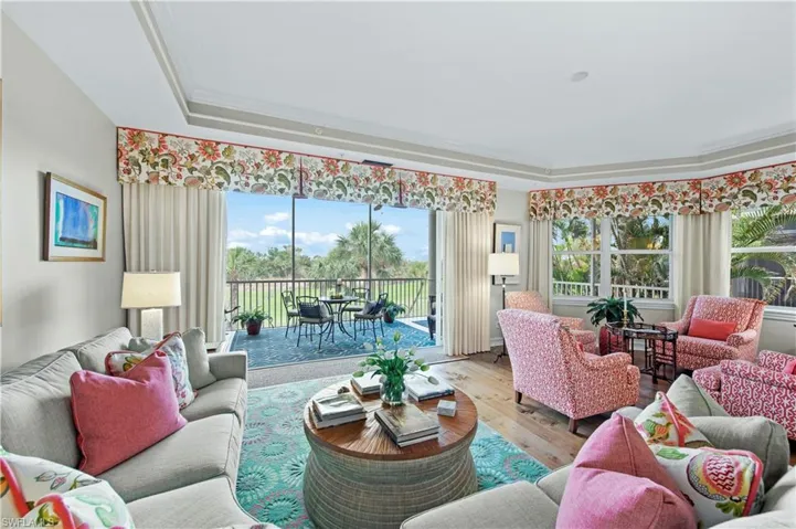 Living room featuring hardwood / wood-style floors and a tray ceiling