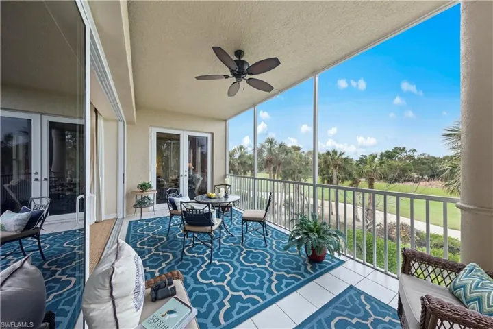 Sunroom / solarium featuring ceiling fan and french doors