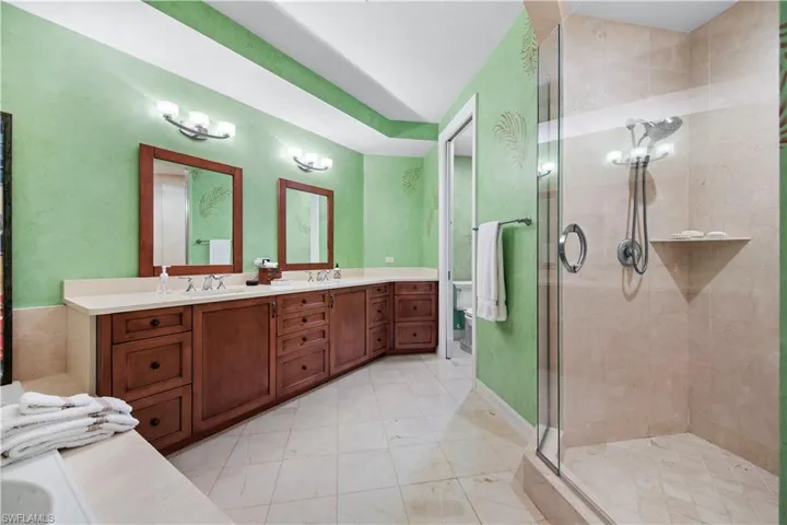 Bathroom featuring an enclosed shower and vanity