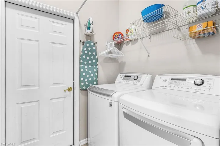 Laundry room with door to the garage and utility sink just outside the garage door